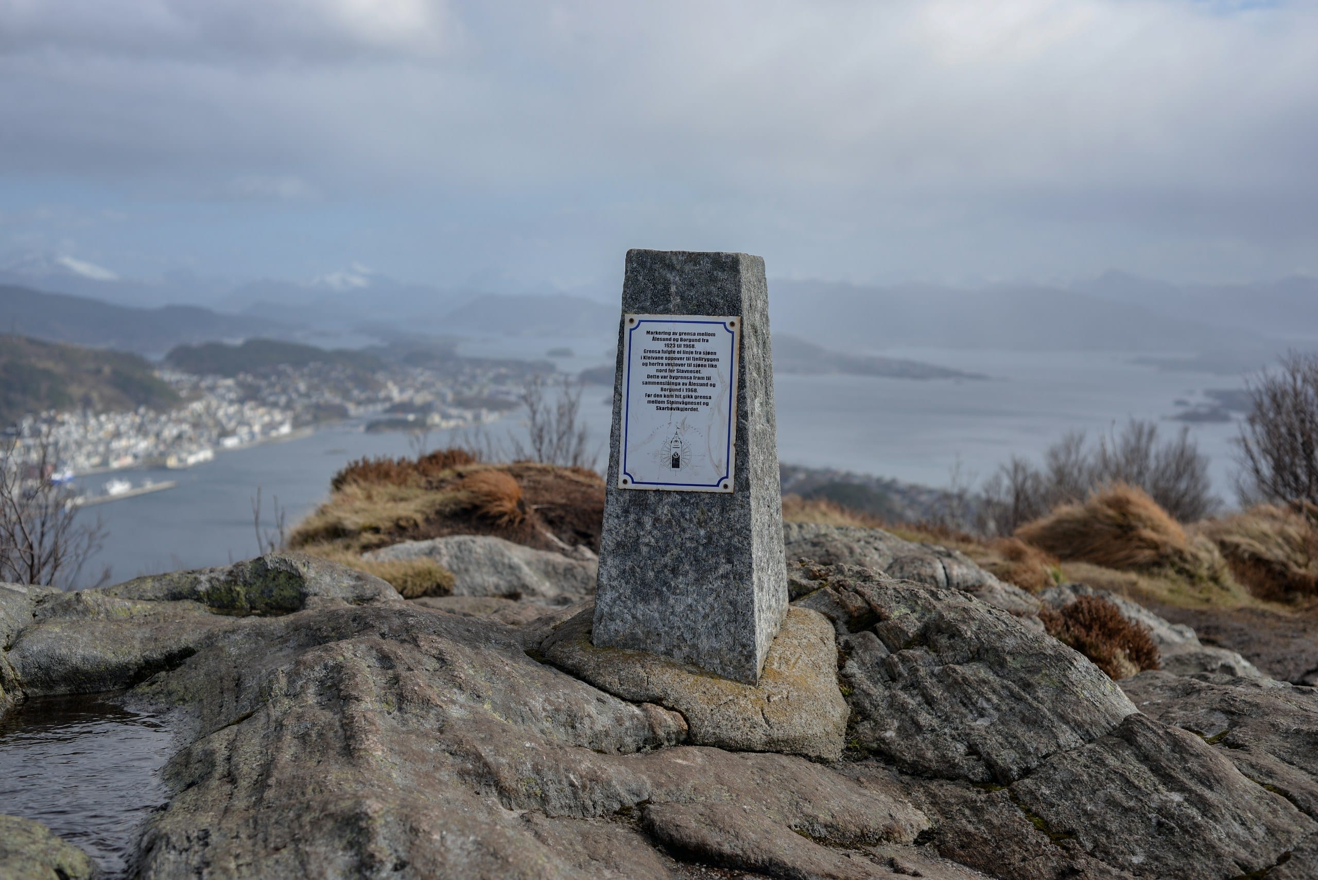 The Fjellstua viewpoint on Aksla hill overlooking Ålesund's harbour and Art Nouveau rooftops below a cloudy sky