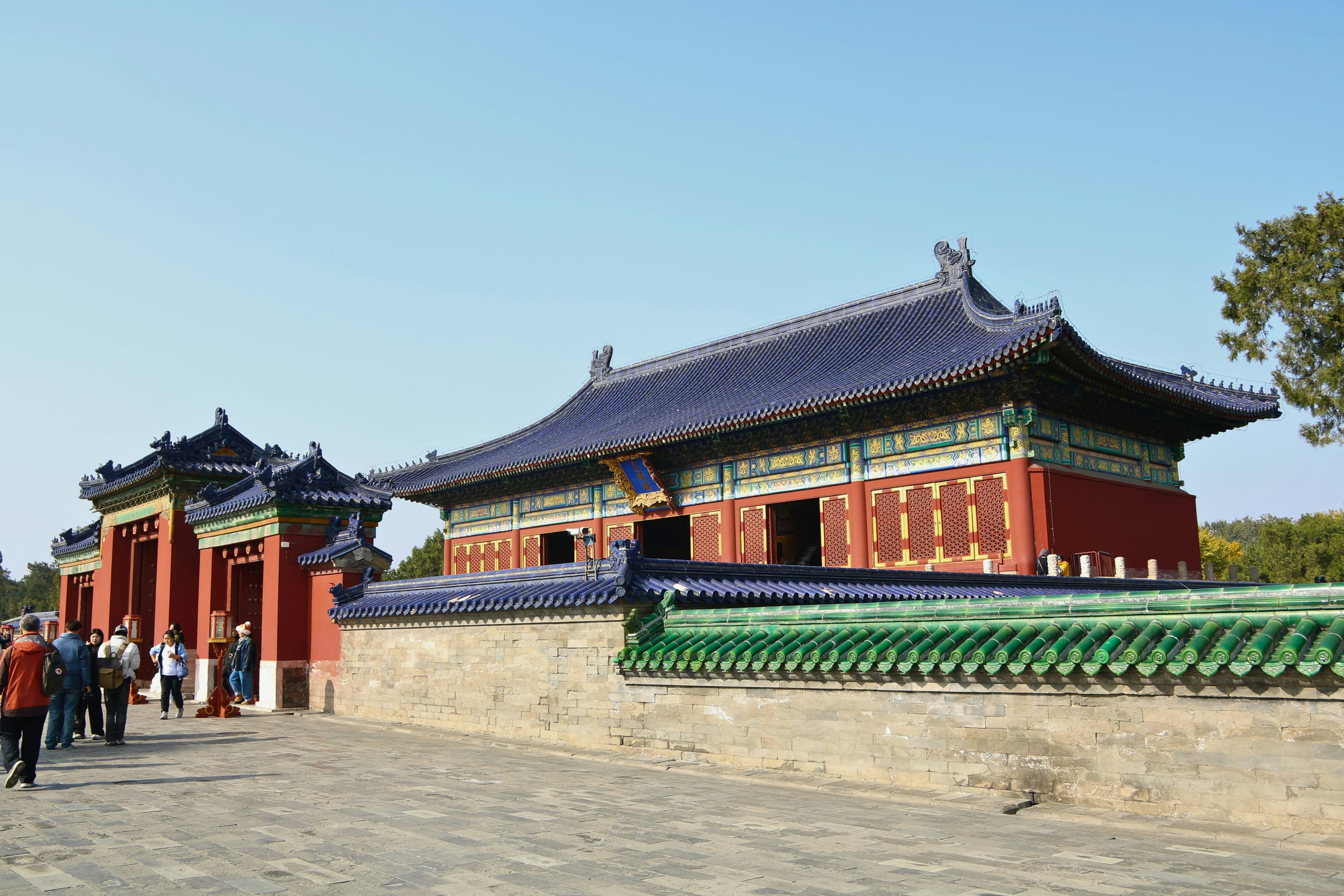 The Temple of Heaven's circular Hall of Prayer for Good Harvests with its blue tiled roof rising above red walls in Beijing