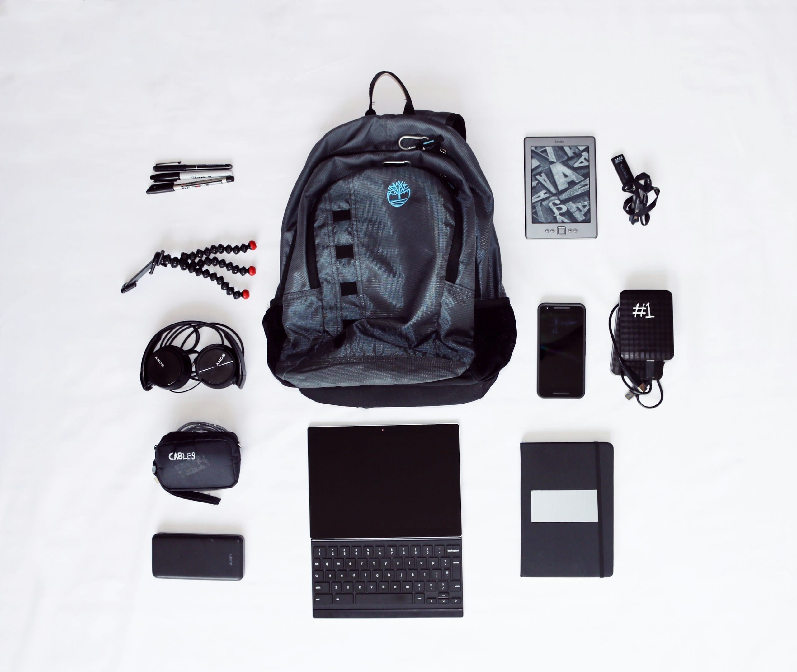 A lightweight nylon daypack folded down into a small stuff pouch next to the unfolded full-size bag